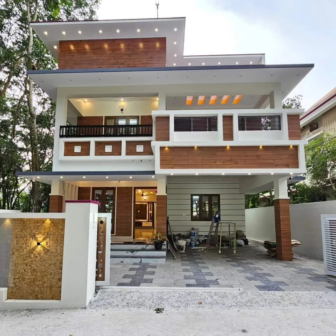 Contemporary villa facade with wood ceiling accents and exterior spotlights